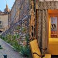 Pictures of the Grignan Castle entrance with two towers, and of the masters bed.